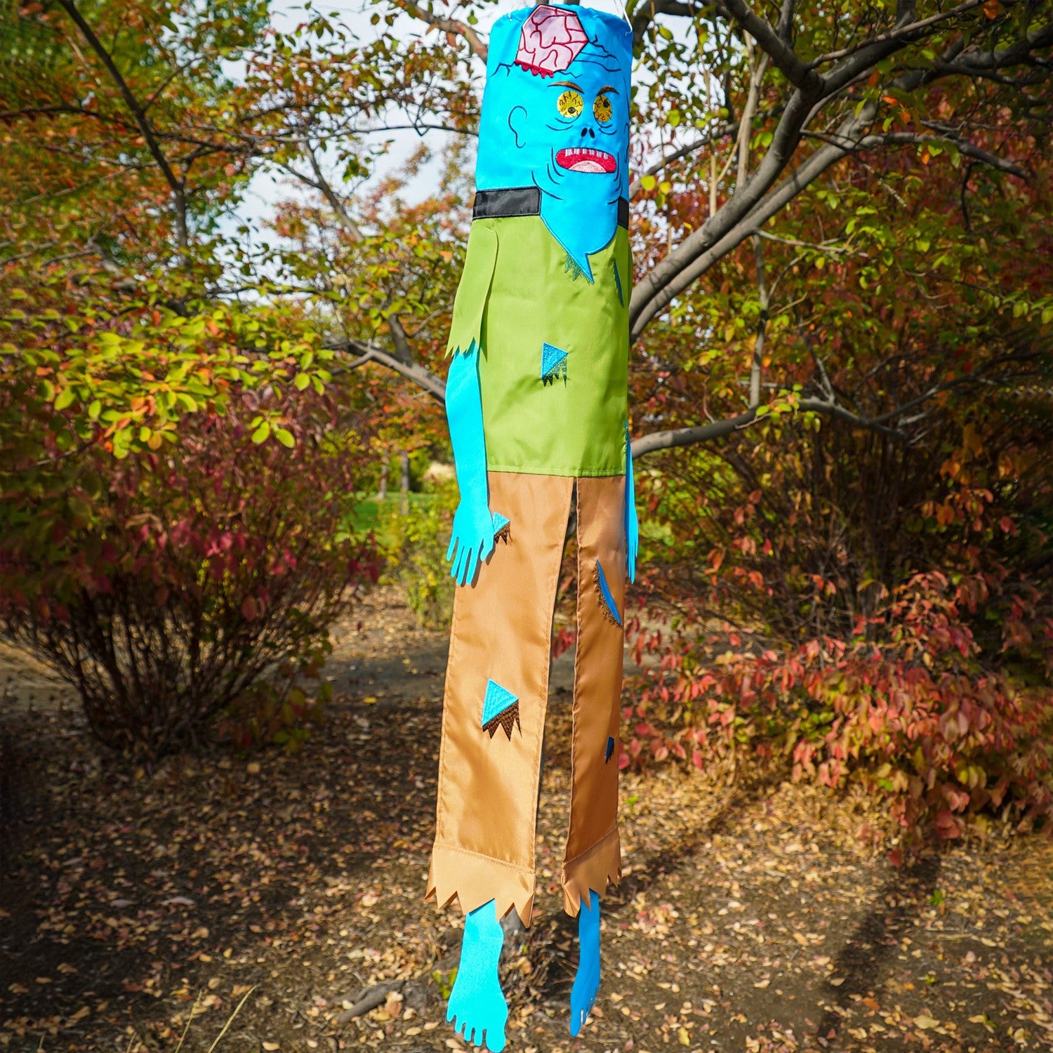 Colorful Zombie 40" Breeze Buddy Halloween decoration with free-flowing arms and legs, displayed outdoors swaying in the breeze.
