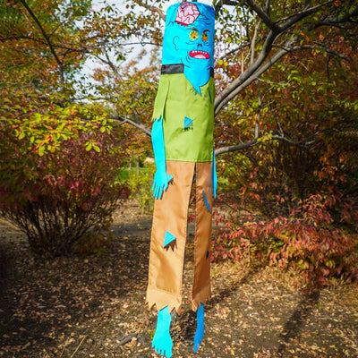 Colorful Zombie 40" Breeze Buddy Halloween decoration with free-flowing arms and legs, displayed outdoors swaying in the breeze.