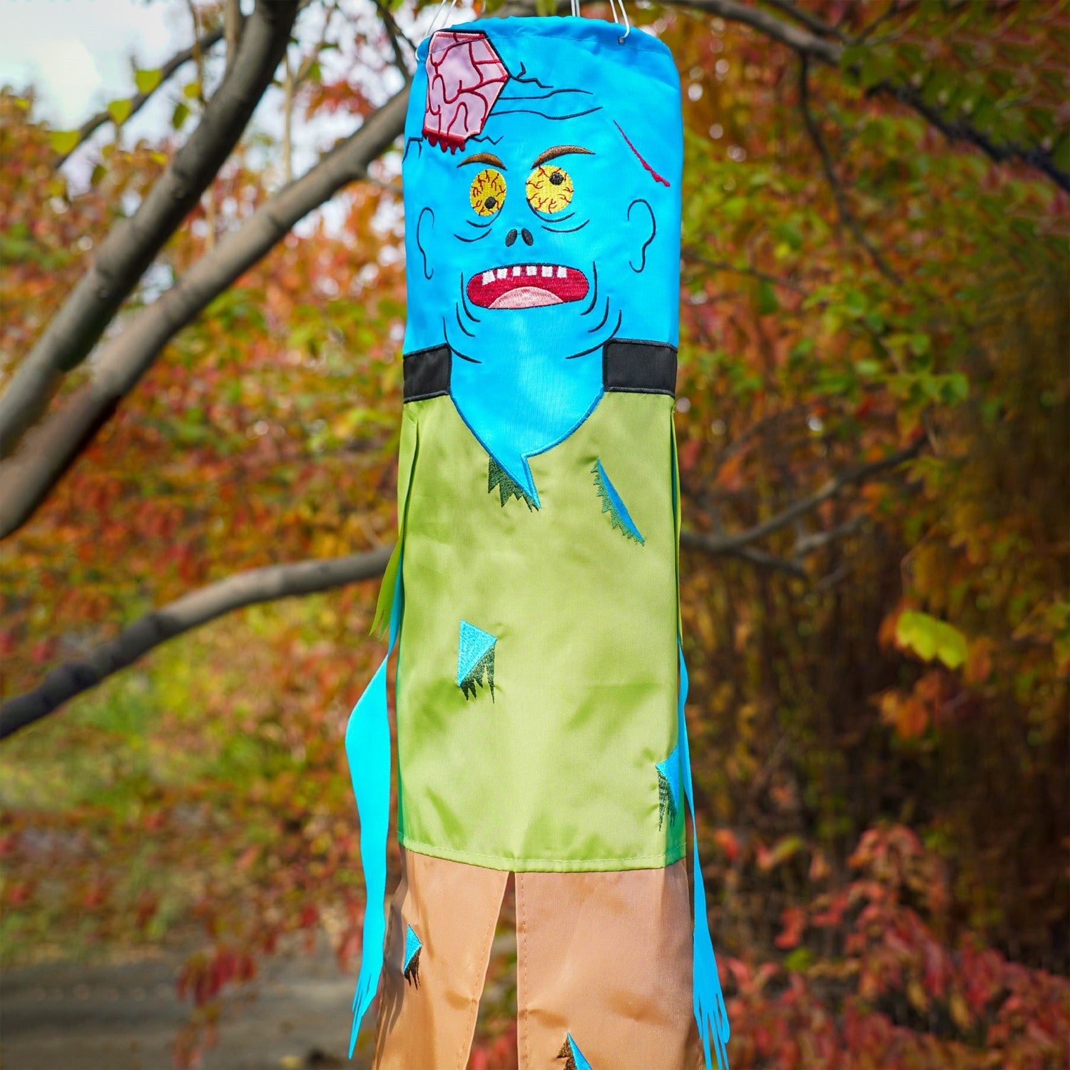 Colorful Zombie 40" Breeze Buddy Halloween decoration with free-flowing arms and legs, displayed outdoors swaying in the breeze.